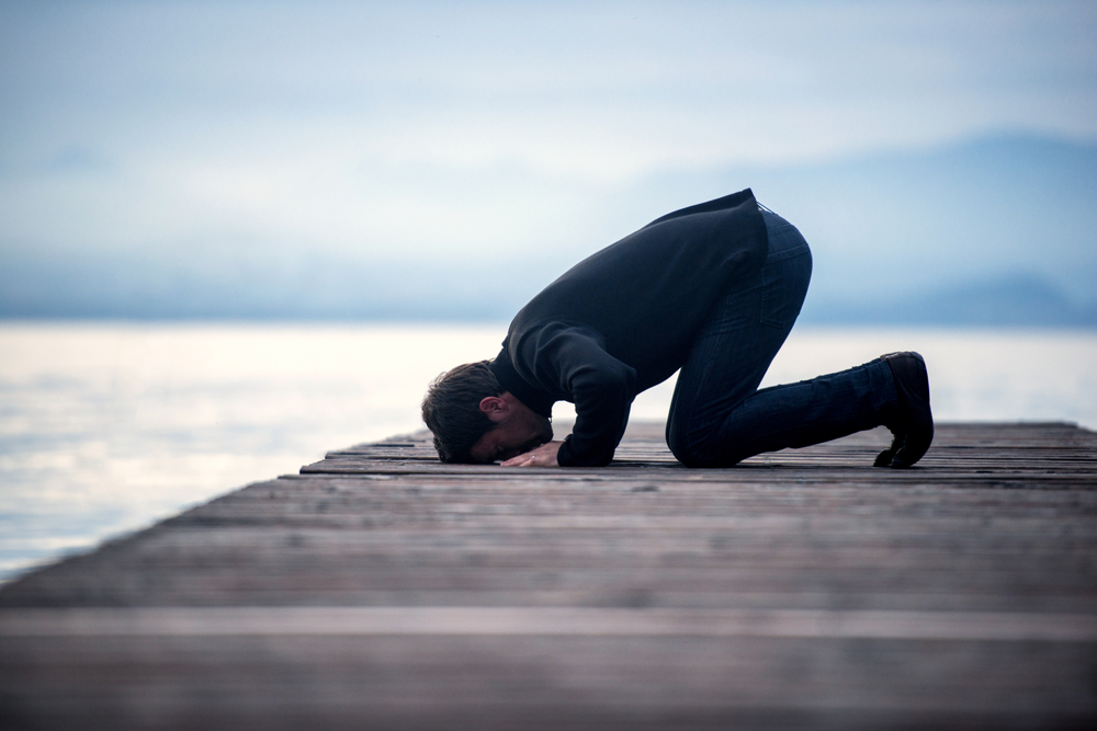 Islamic,Man,Praying,On,A,Wooden,Pier,In,Dusk